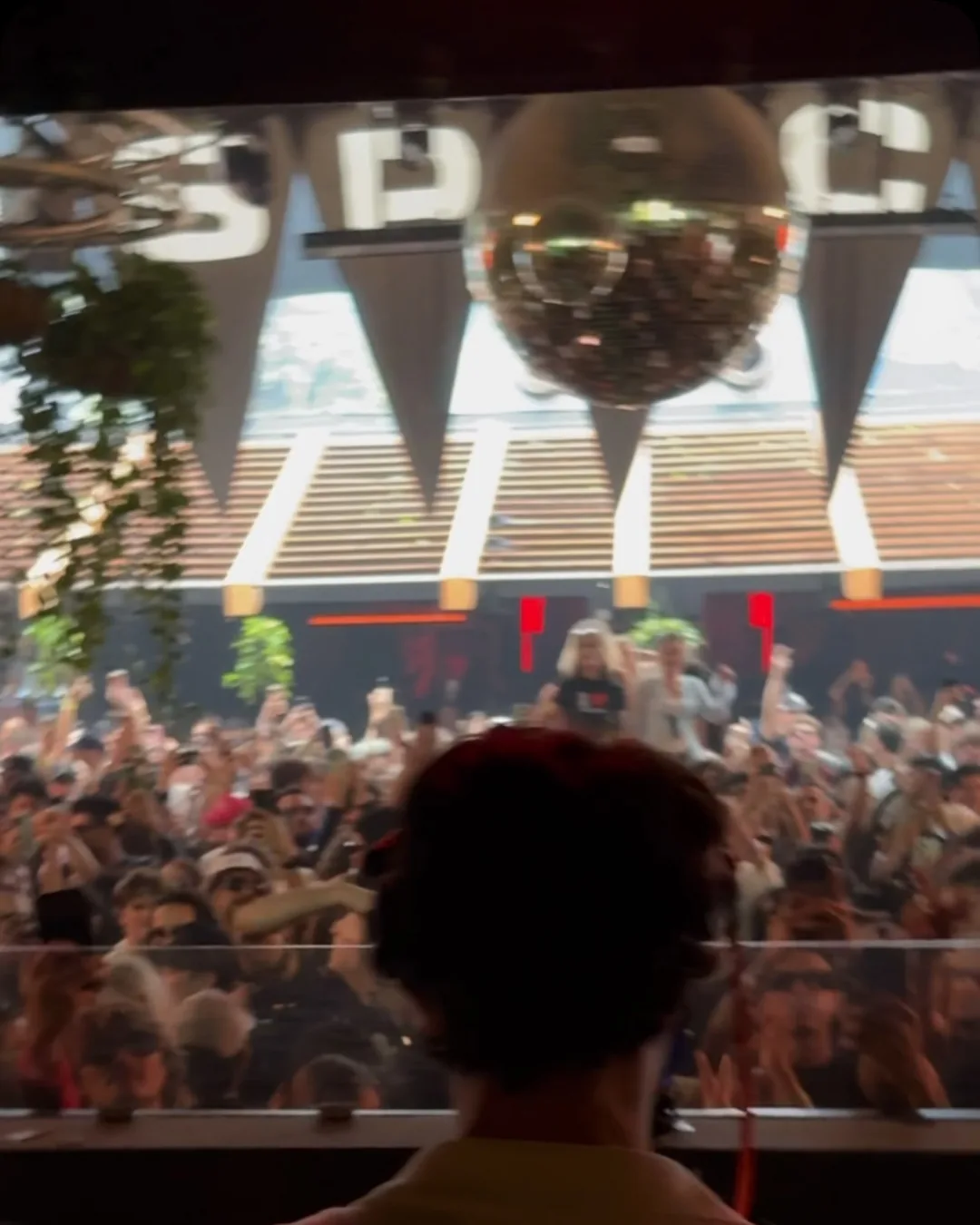 The Space terrace from behind the DJ booth, the crowd below the lettering.