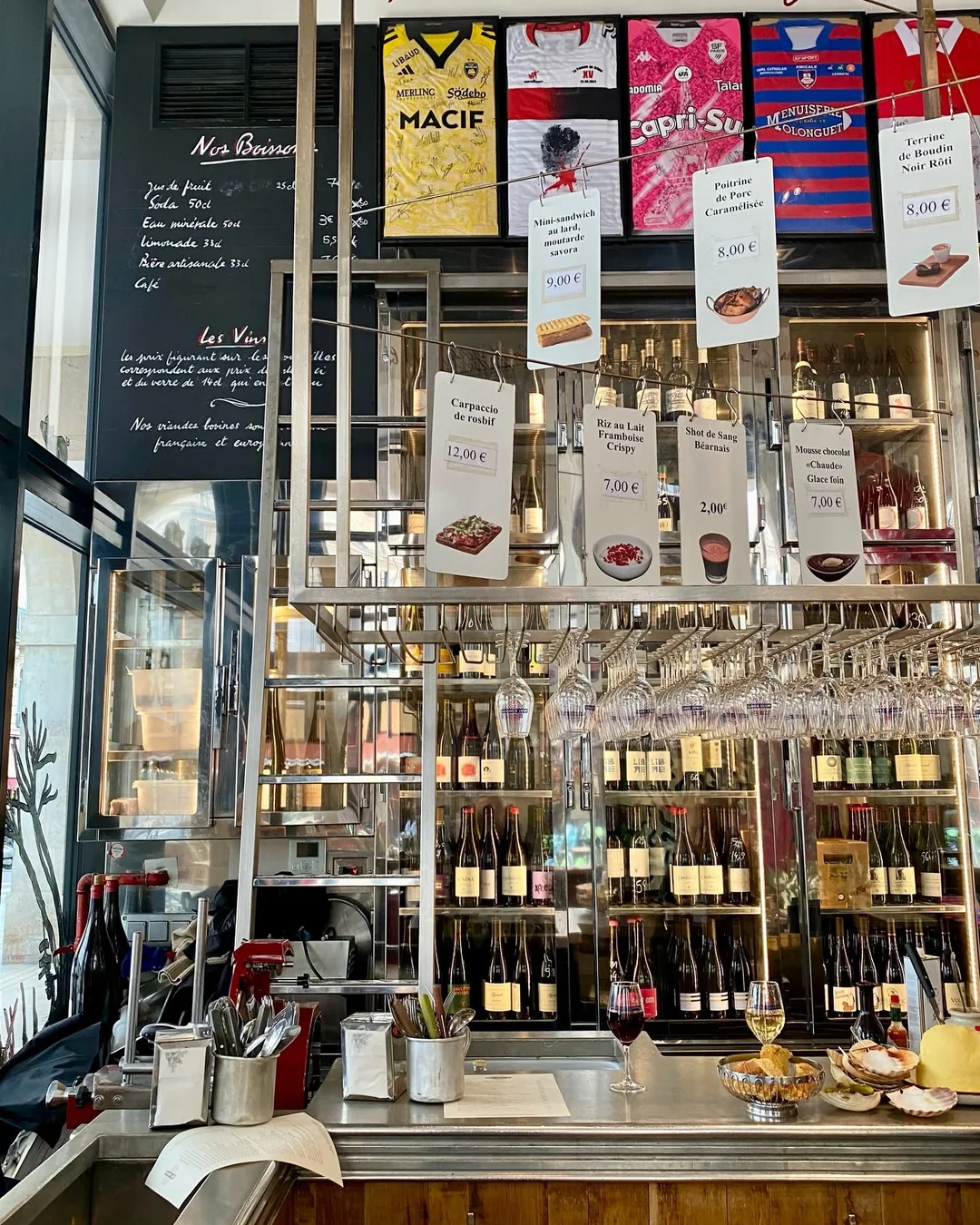 The counter at L'Avant Comptoir du Marché, the menus hanging overhead.