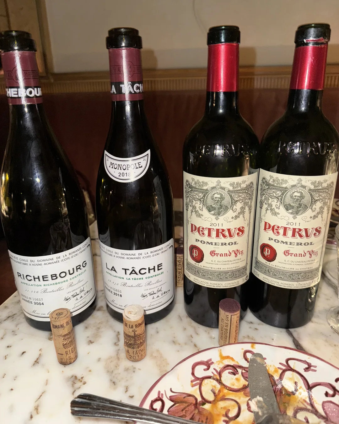 Petrus, La Tâche and Richebourg on a dinner table in Paris.