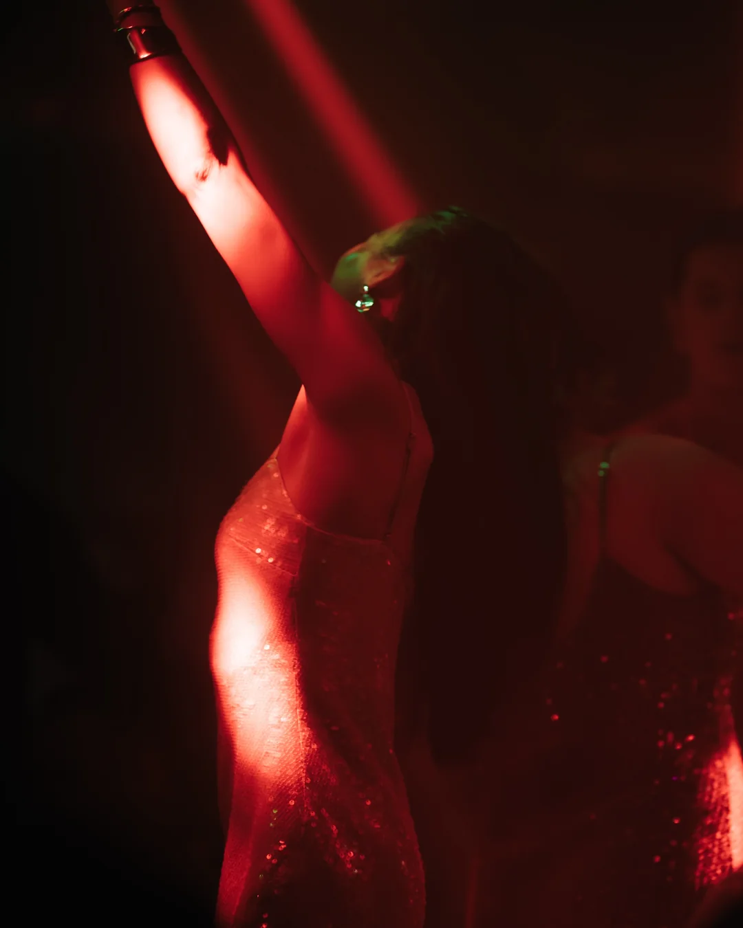 A dancer under red light at La Petite Plage, Gustavia.