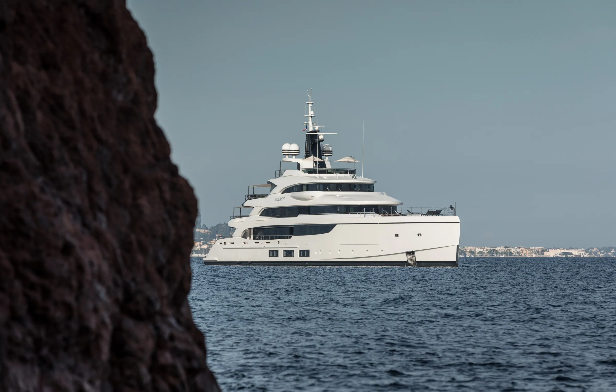 TRIUMPH at anchor, framed by the red rock of the Esterel.